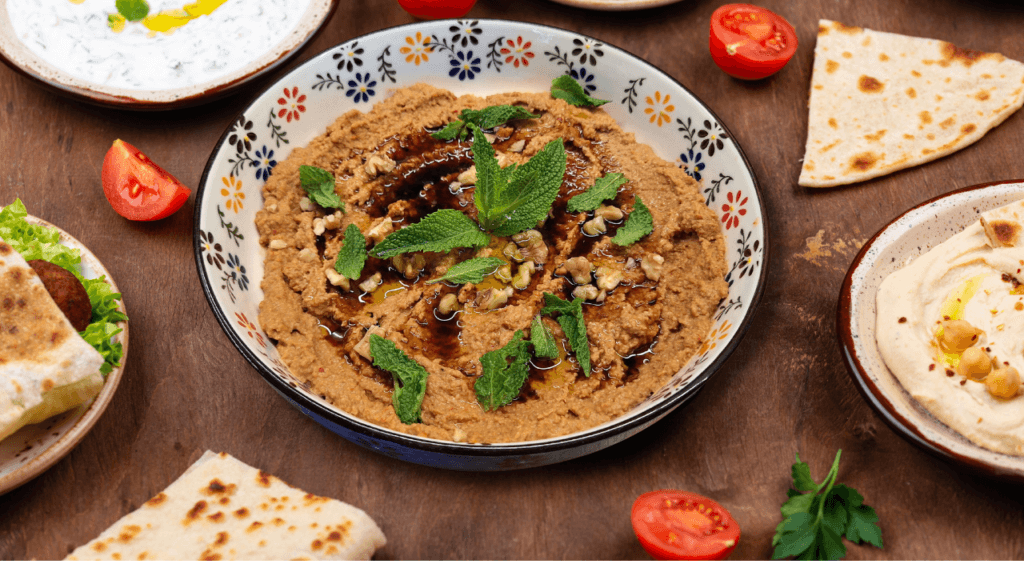 Muhammara served with flatbread, hummus and other mezze.